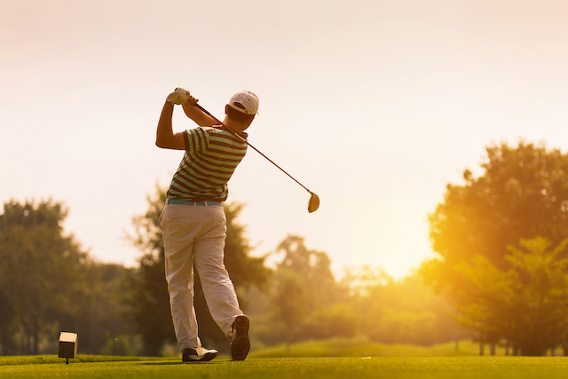 Golfer teeing off at Riverfront Golf Club